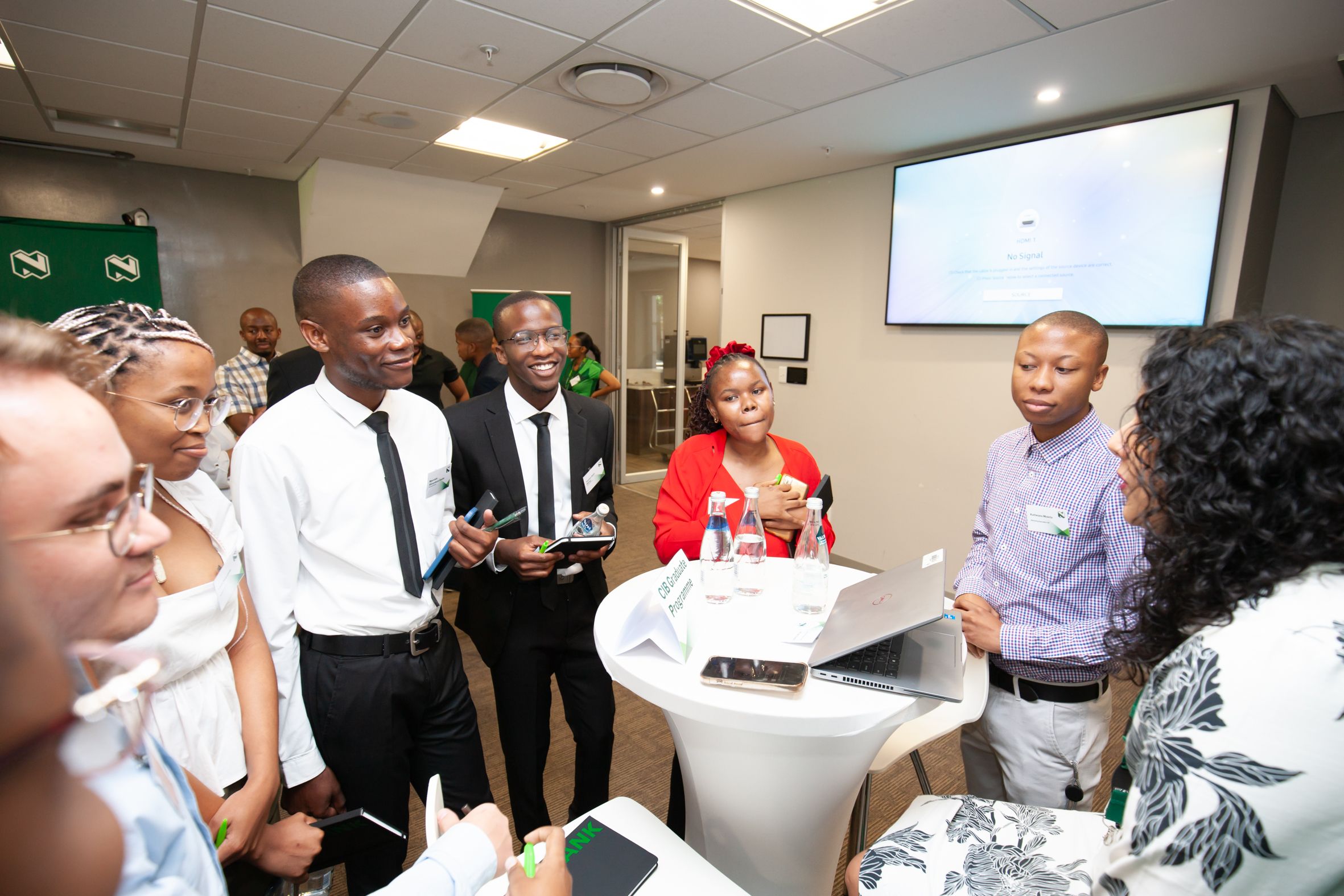 Participants gathered around a table in discussion at Nedbank’s work-readiness programme